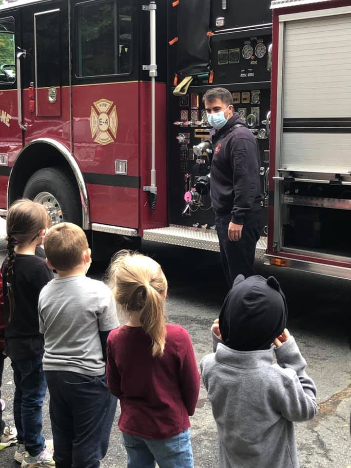 4 kids listening to 1 firefighter 
