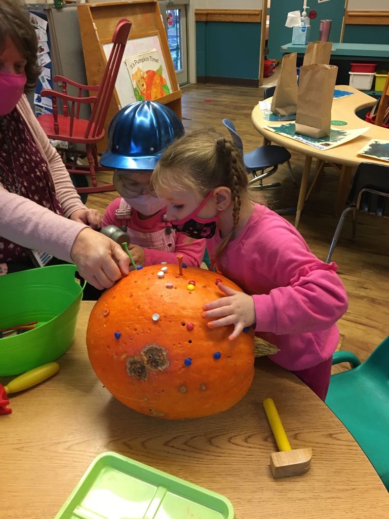 one student decorating a pumpkin