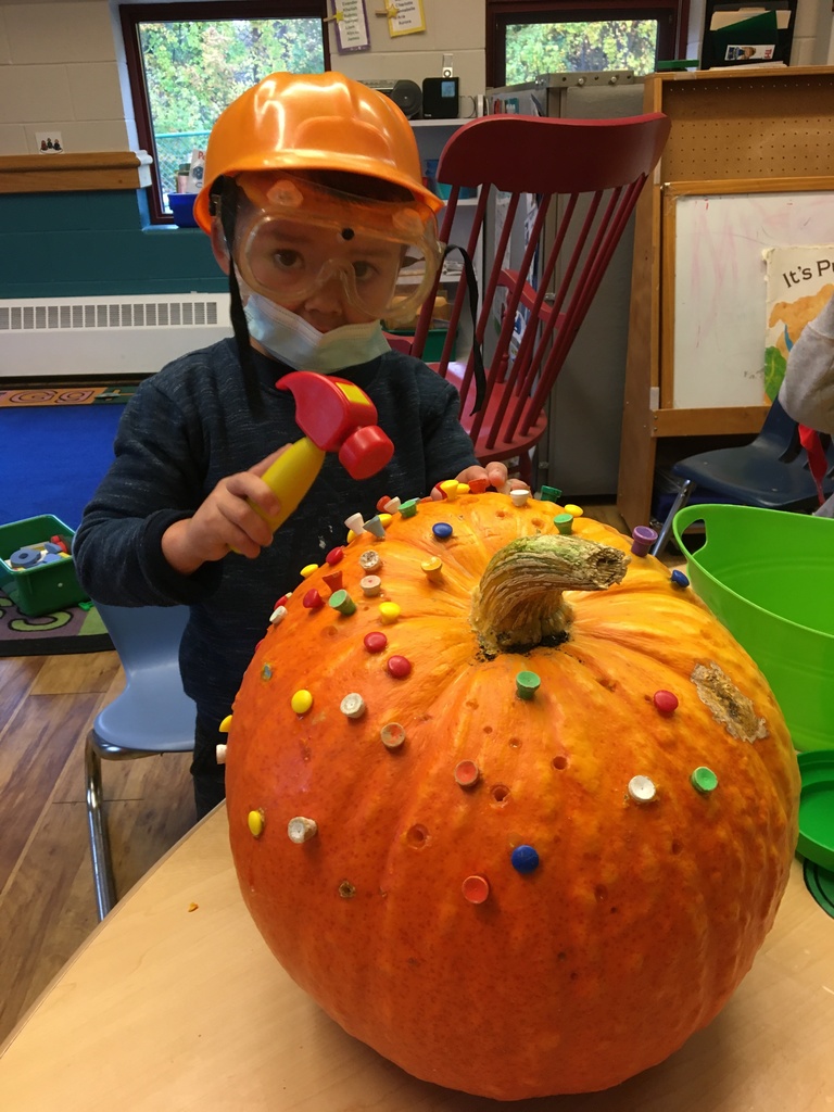 one student decorating a pumpkin