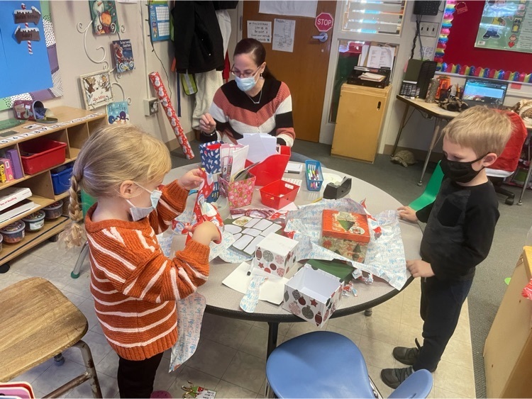 preschoolers wrapping gifts 