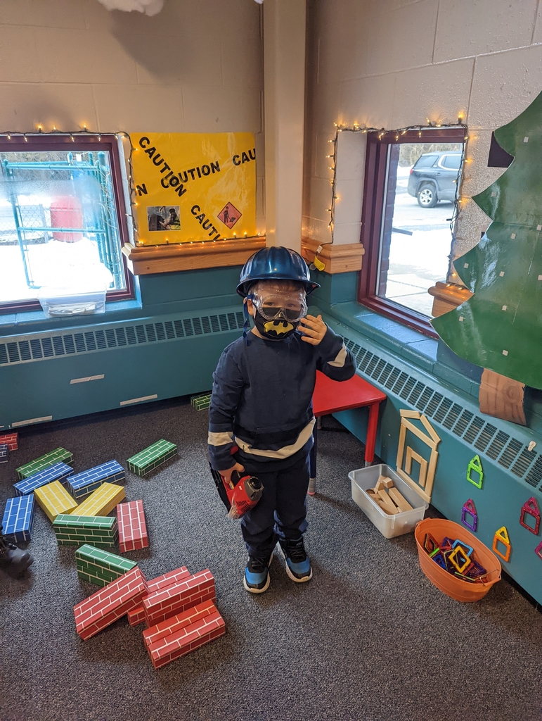 boy playing in the construction area of classroom