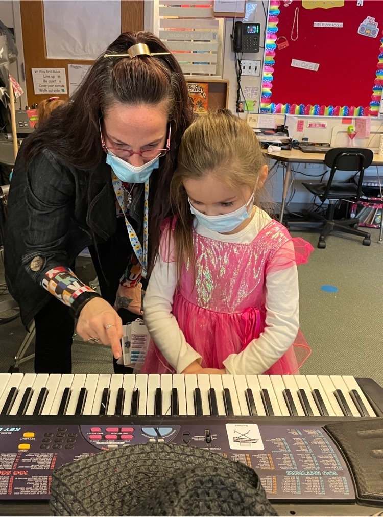 student plays keyboard with teacher 