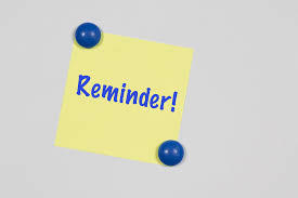 Reminder sticky note with 2 blue thumb tacks