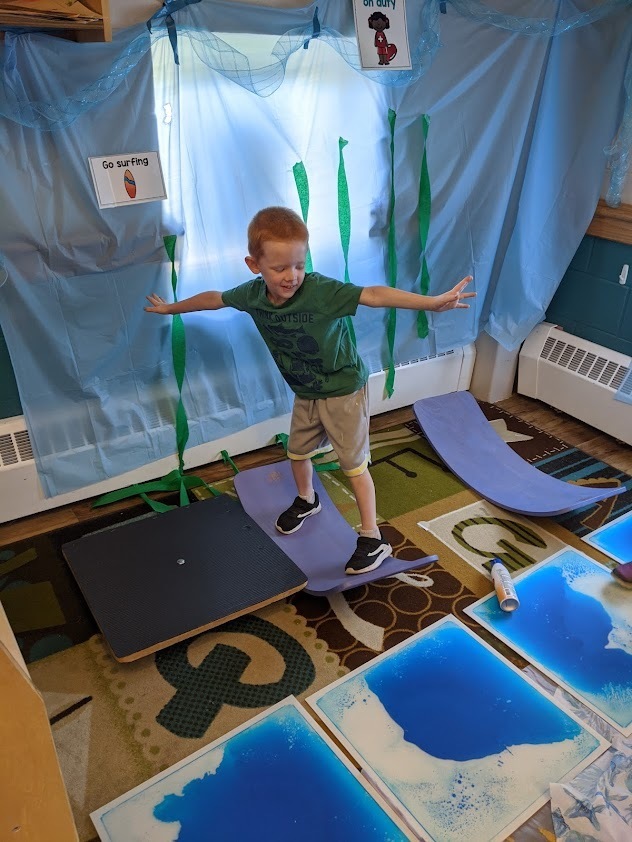 One student balances as he surfs on the wobble boards.